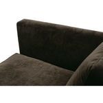 Top-down close-up of the right armrest and seat cushion in dark brown fabric