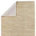 Back corner folded to reveal rug's stitched beige fabric backing