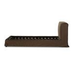 Side elevation of brown linen slipcovered bed frame without mattress