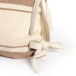 Bottom corner of pillow showing knotted fabric ties and stripe pattern wrapping around