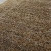 Close-up shot showing textured pile and neutral hues of Heritage Clay rug under natural light on tiled floor