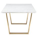 Table viewed from short end highlighting trapezoidal brushed gold legs and marble edge thickness
