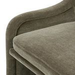 Detail of welt piping along side seam on Blaire Dining Chair's olive velvet upholstery
