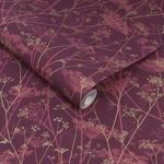 Rolled wallpaper showing texture and gold floral print on burgundy background