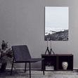 Two black candle holders styled with tall gray candles in a minimalist modern room setting