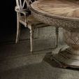 Close-up of scallop fretwork apron and pedestal base with rustic wood texture, beside a wooden chair