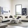 Lola Modular Sectional configured in a large bright living room with neutral rug and modern art on walls