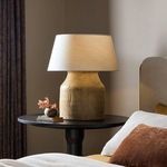 Baku Table Lamp styled on black side table in bedroom with neutral wall and furnishings