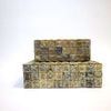 Close-up angle of stacked bone boxes highlighting fine cube inlay texture