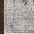 Close-up of Bonney Stone charcoal rug corner on dark wood floor highlighting texture and pattern