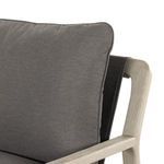 Right armrest with plush charcoal seat cushion resting on weathered grey wood frame