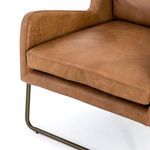 Detail of stitched leather seat cushion and sled base curved metal legs