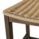 Close-up of woven seat edge curve and wood frame joint