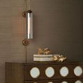 Severn Wall Sconce styled mounted on wall above wooden dresser with decorative gold fish sculptures