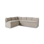 Banquette viewed at an angle showing cushioned back pillows and soft, tailored slipcover texture