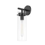 Wall sconce with old bronze finish featuring clear cylindrical glass shade and visible elongated bulb
