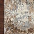 Top corner view of Theory Dove Bark rug styled on dark hardwood floor highlighting texture and edge binding