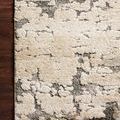 Theory Taupe Grey Rug with plush pile and abstract pattern in taupe and grey on dark wood floor
