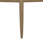 Close-up of tapered amber wood leg of Artie Dining Chair showing wood grain detail