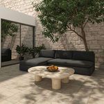 Side view of Miles outdoor sofa in courtyard showing sectional left side and coffee table