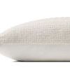 Side profile view showing thickness and texture contrast between woven top and smooth back pillow
