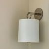 Side view of French Cuff Sconce showing angle of metal arm and shade edge in neutral corner wall
