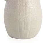 Close-up showing fine ceramic texture and gently carved vertical lines on the lower half of the vase
