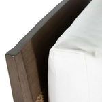 Close-up of back corner showing oak frame with white cushion edge