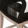 Close-up of woven black rope texture and fabric seat corner on light mahogany frame