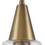 close-up of brushed antique brass conical metal fixture above clear glass shade