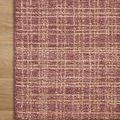 Close-up of Polly Berry Natural Rug edge and woven surface on light wood floor
