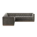 Side angle showing tufted velvet cushions and nailhead trim on sectional edges