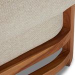 Teak wood frame curve detail supporting the chaise’s seat cushioning