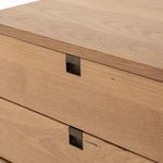 Lower front close-up showing oak drawer front and satin brass leg detail