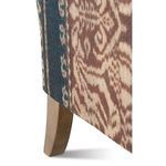Close-up of sofa armrest upholstery seam and bold stripe fabric pattern