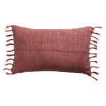 Rectangular rose-hued linen pillow with knotted tassels on both ends, rustic texture