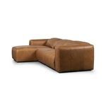 Angled rear side of sectional showcasing curved backrest and chaise extension
