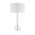 Side profile of Deville Table Lamp showing clear optic crystal midsection and solid disc base on wood surface