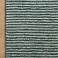 Rug corner on wood floor highlighting hand-tufted edges and striped pattern alignment