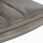 Detailed close-up of leather seat cushion emphasizing tight seams and soft texture
