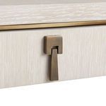 Detailed view of the antique bronze drawer pull on the light quarter-sawn oak surface.