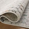 Curled edge revealing the rug’s backing texture and thickness