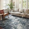 Austen Ocean Rug styled in bright living room under sofa and chair with natural light