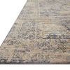 Angled edge view highlighting low pile height and tightly finished edge stitching on Indra Charcoal Natural rug