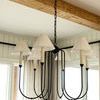Chandelier view from below, showing six pleated shades and surrounding window curtains