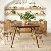 Jamie Natural Sand Rug in dining room setting shown from wider perspective with arched niche and shelving in background