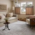 Hollis Grey / Ivory Rug laying flat in a living room setting with neutral furniture and soft natural light