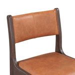 Close-up of upper backrest section showing leather upholstery and seam stitching