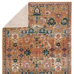back side of rug turned over revealing a solid light underside contrasting the colorful top