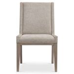 Front view of Linea side chair showing upholstery detail in soft beige with light stained ash frame